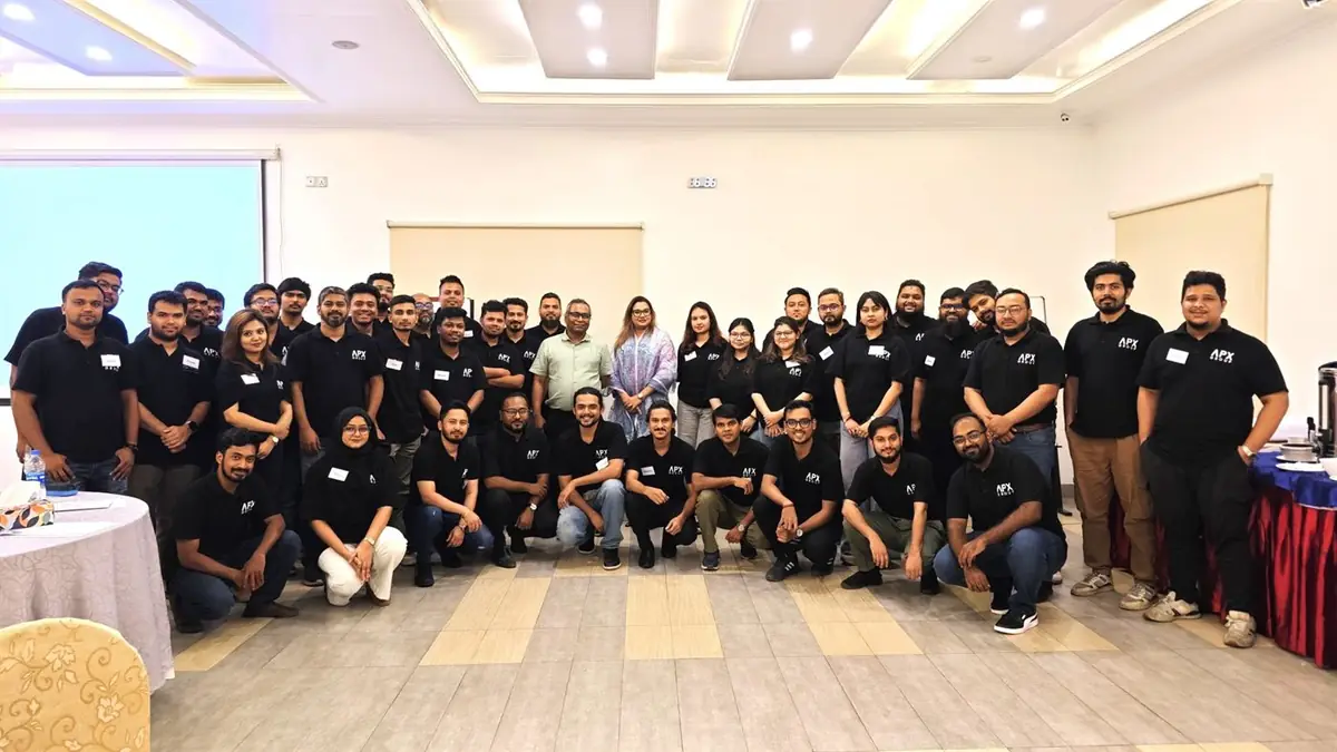 The wider Apex DMIT team in branded shirts at a company offsite